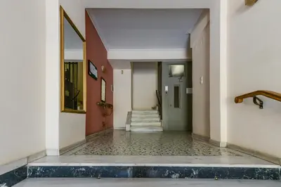 an empty hallway with a tile floor and a staircase at Athenean Classic Apartment at Acropolis Museum & Metro in Athens