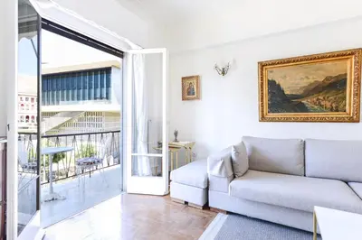 a living room with a couch and a window at Athenean Classic Apartment at Acropolis Museum & Metro in Athens