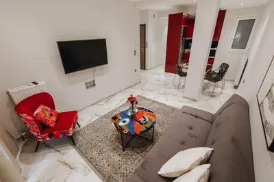 a living room with a couch and a tv at Sweet Dreams 2 Bedroom VIPGreece in Athens