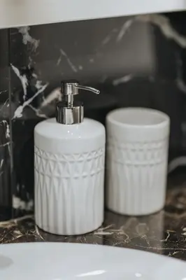 a white soap dispenser sitting next to two toilets at Sweet Dreams 2 Bedroom VIPGreece in Athens