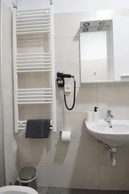a bathroom with a sink and a mirror and a toilet at acropolis super cosy apartment in Athens