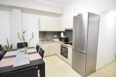 a kitchen with a large stainless steel refrigerator at acropolis super cosy apartment in Athens