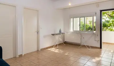 a room with white walls and a window and a table at Porto sea view house - 15min from Athens airport - AC - WIFI - PARKING in Porto Rafti