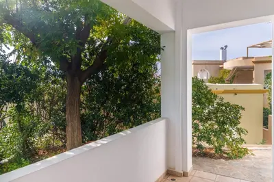a window view of a tree from a house at Porto sea view house - 15min from Athens airport - AC - WIFI - PARKING in Porto Rafti