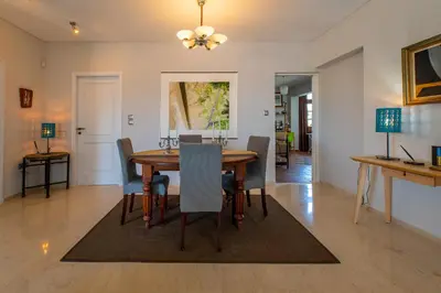 a dining room with a table and chairs at Spacious apartment in Kavouri in Athens