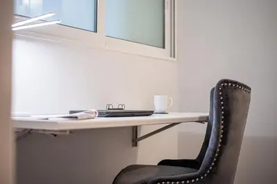 a chair sitting in front of a desk at Hermes Apartments, 2 bedrooms, great facilities! in Athens
