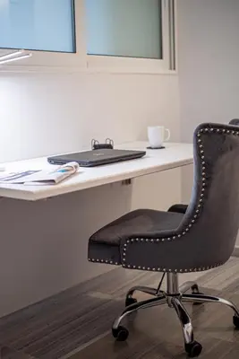 a desk with a black chair in front of a table at Hermes Apartments, 2 bedrooms, great facilities! in Athens