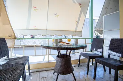 a table and chairs in a room with a window at Hermes Apartments, 2 bedrooms, great facilities! in Athens