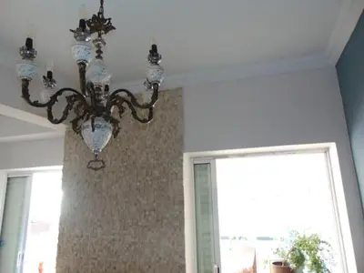 a chandelier hanging from a ceiling in a room at Lovingly restored apartment Galatsi in Athens