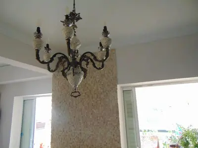 a chandelier hanging from a ceiling in a room at Lovingly restored apartment Galatsi in Athens