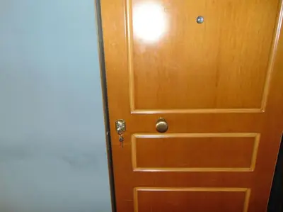 a wooden door with a door knob on it at Lovingly restored apartment Galatsi in Athens