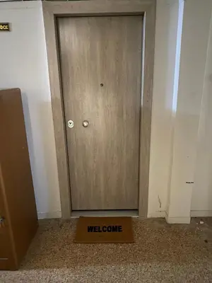 a door with a welcome sign in front of it at Theo Appartement Athen in Athens