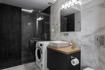 a bathroom with a washing machine and a sink at Loft in Psirri by Liberty's Canvas in Athens