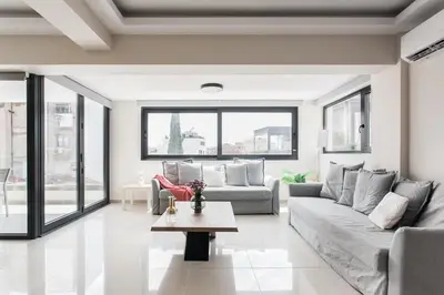 a living room with a couch and a table at Loft in Psirri by Liberty's Canvas in Athens