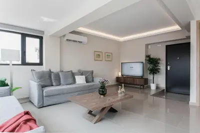 a living room with a couch and a coffee table at Loft in Psirri by Liberty's Canvas in Athens