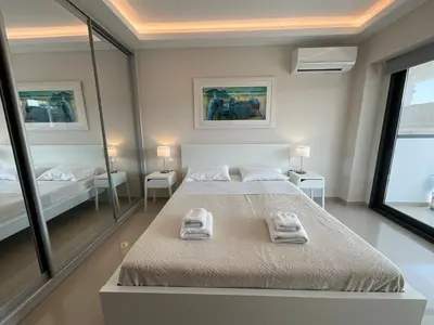 a bedroom with two beds and two mirrors at Loft in Psirri by Liberty's Canvas in Athens