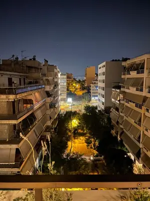 a view of a city at night with buildings at Athens Neos Kosmos penthouse, sea and city view in Athens