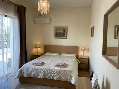 a bedroom with a bed with two pillows on it at Athens Neos Kosmos penthouse, sea and city view in Athens