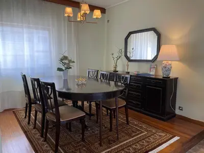 a dining room with a table and chairs and a mirror at Athens Neos Kosmos penthouse, sea and city view in Athens