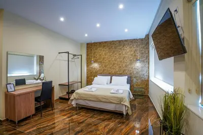 a hotel room with a bed and a desk and a desk at Athens City Living at Akadimias in Athens