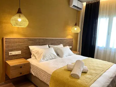 a bedroom with a bed with two towels on it at G&W Luxury Rooms in Athens