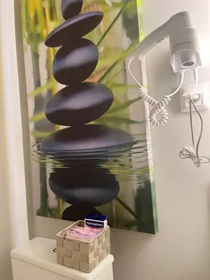 a sculpture of a stack of black rocks on a wall at G&W Luxury Rooms in Athens
