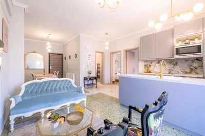 a kitchen and living room with a couch and a table at Luxury Penthouse in prime central Athens Thissio by GHH in Athens