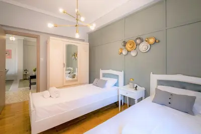 a bedroom with two beds and a mirror on the wall at Luxury Penthouse in prime central Athens Thissio by GHH in Athens