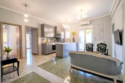 a living room with a couch and a kitchen at Luxury Penthouse in prime central Athens Thissio by GHH in Athens