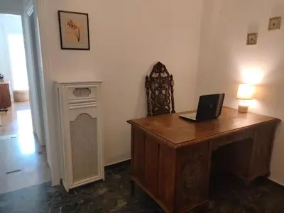 a room with a desk with a laptop on it at AcropolisCozyStay in Athens