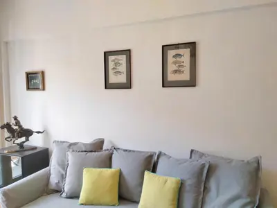 a living room with a couch with pillows on it at AcropolisCozyStay in Athens