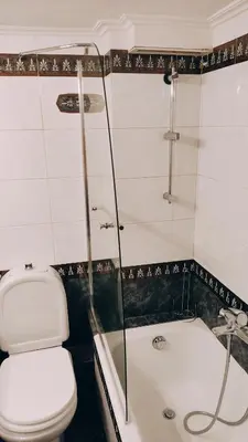 a bathroom with a toilet and a shower and a tub at AcropolisCozyStay in Athens
