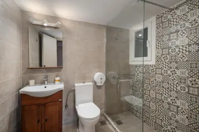 a bathroom with a toilet and a sink and a shower at Victoria Boutique Studios in Athens