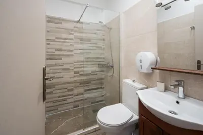 a bathroom with a toilet and a sink at Victoria Boutique Studios in Athens