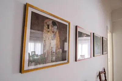 a group of pictures hanging on a wall at The Rebel's Temple in Athens