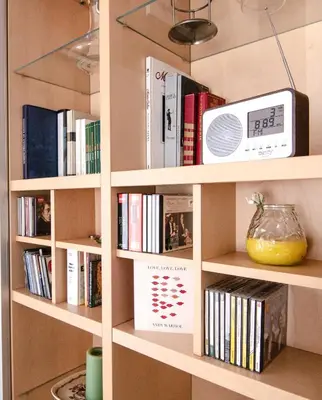 a book shelf filled with books and a tv at The Rebel's Temple in Athens