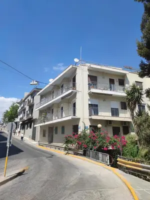 a white building on the side of a street at The Rebel's Temple in Athens