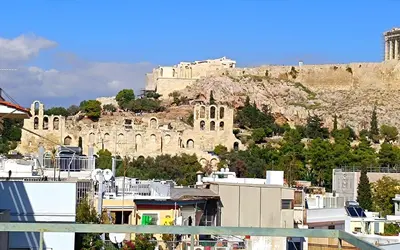 a city with a castle on a hill with buildings at The Rebel's Temple in Athens