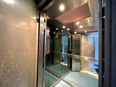 a glass door in a room with a window at The Best Penthouse View -Sea View Athens Reviera & SNFCC in Athens