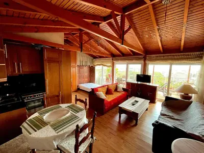 a living room with a red couch and a table at The Best Penthouse View -Sea View Athens Reviera & SNFCC in Athens