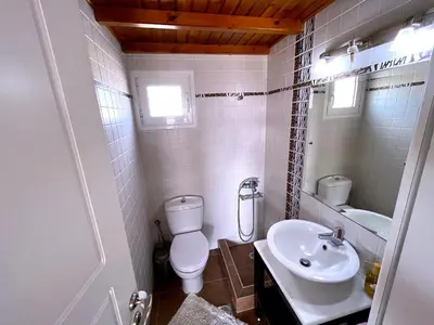 a small bathroom with a toilet and a sink at The Best Penthouse View -Sea View Athens Reviera & SNFCC in Athens