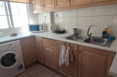 a kitchen with a sink and a washing machine at Plaka's Heart in Athens