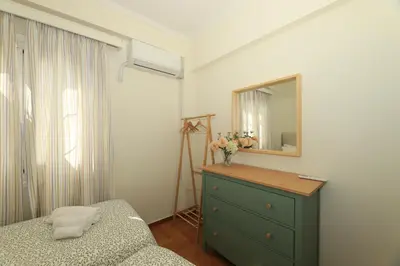 a bedroom with a green dresser and a mirror at Plaka's Heart in Athens