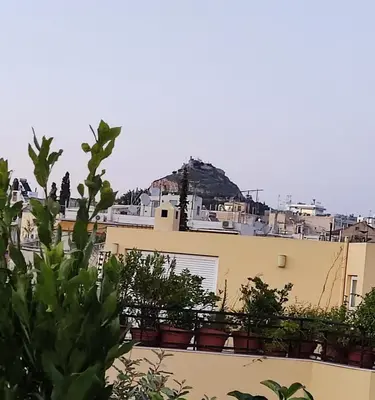 a view of a building with potted plants on it at Plaka's Heart in Athens
