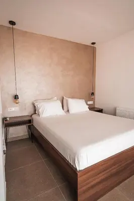 a bedroom with a large bed with two pillows at Suites with magical view & jacuzzi in Athens