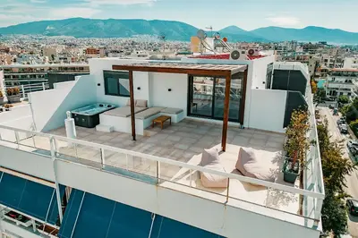a balcony on a building with a view of a city at Suites with magical view & jacuzzi in Athens