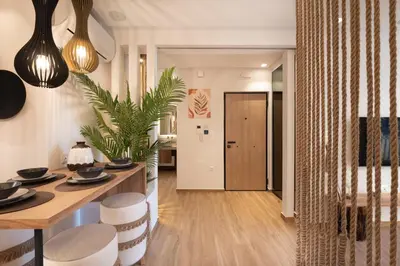 a living room with a table and chairs and a hallway at Apollonos at Heart of Plaka in Athens