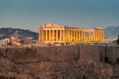 a building with yellow lights on top of a city at Apollonos at Heart of Plaka in Athens