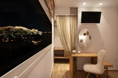a room with a table and a chair next to a window at Apollonos at Heart of Plaka in Athens