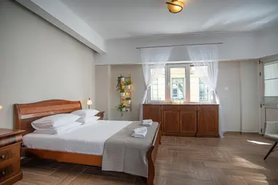 a bedroom with a bed and a desk and a window at Central Calm Apartment in Athens